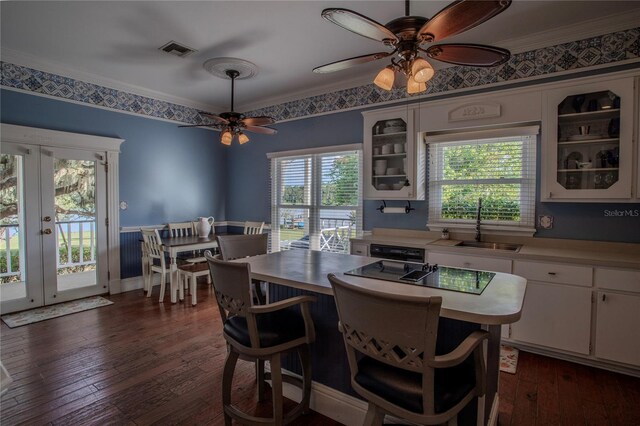 dining area featuring crown molding, french doors, dark hardwood / wood-style flooring, and ceiling fan