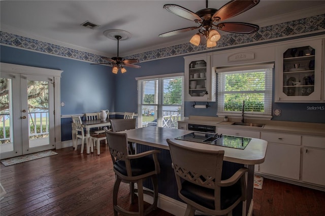 dining space featuring crown molding, sink, dark hardwood / wood-style flooring, and french doors