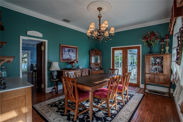 dining space with dark wood-type flooring, ornamental molding, a healthy amount of sunlight, and french doors