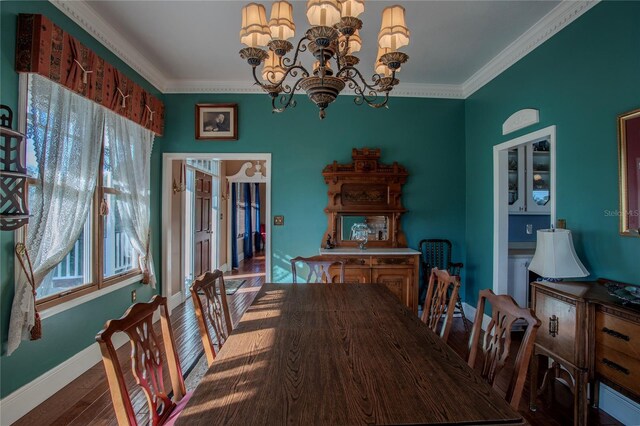 dining space featuring hardwood / wood-style flooring, crown molding, and a chandelier