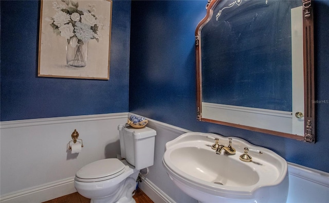 bathroom featuring hardwood / wood-style flooring, toilet, and sink