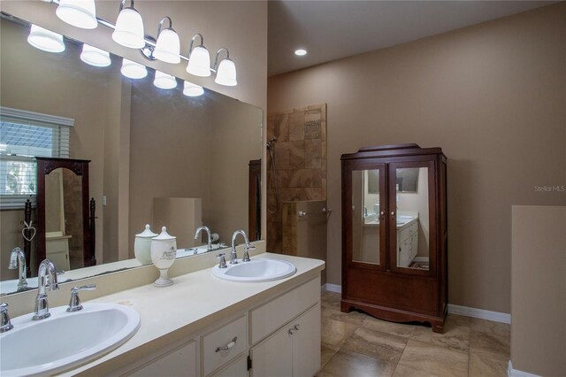 bathroom with tile patterned floors, double sink vanity, and a shower