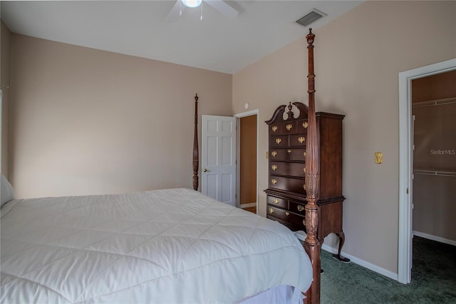 carpeted bedroom featuring a walk in closet, a closet, and ceiling fan