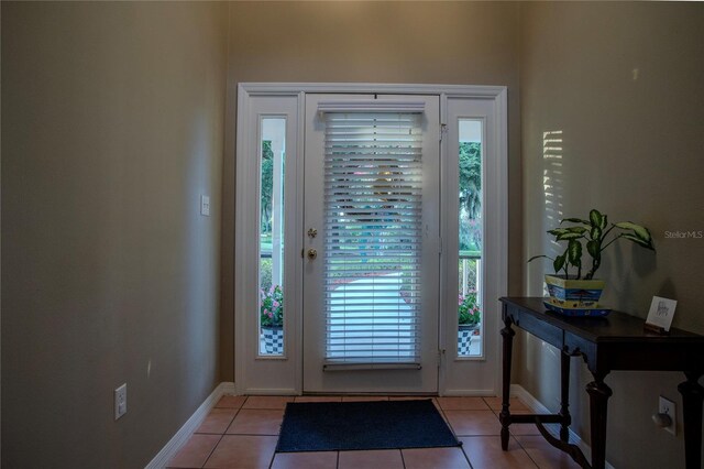 doorway to outside with light tile patterned floors