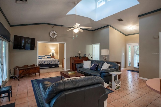 living room with light tile patterned flooring, ceiling fan, high vaulted ceiling, and crown molding