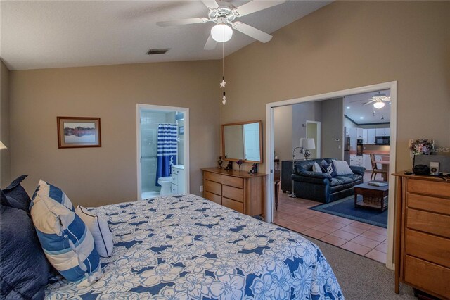 bedroom featuring carpet flooring, vaulted ceiling, ensuite bath, and ceiling fan