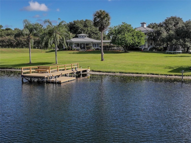 dock area with a yard and a water view