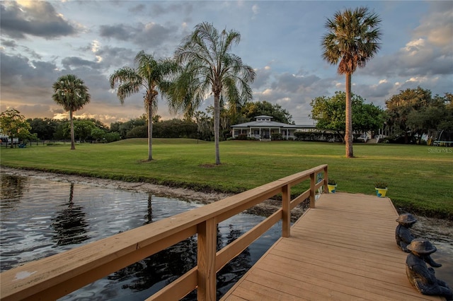 dock area featuring a water view and a yard