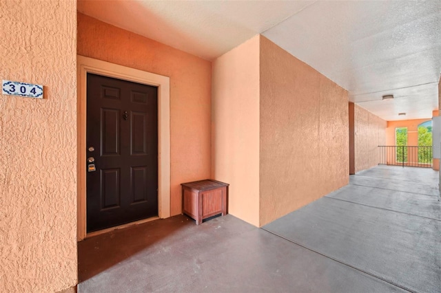 doorway to property featuring stucco siding