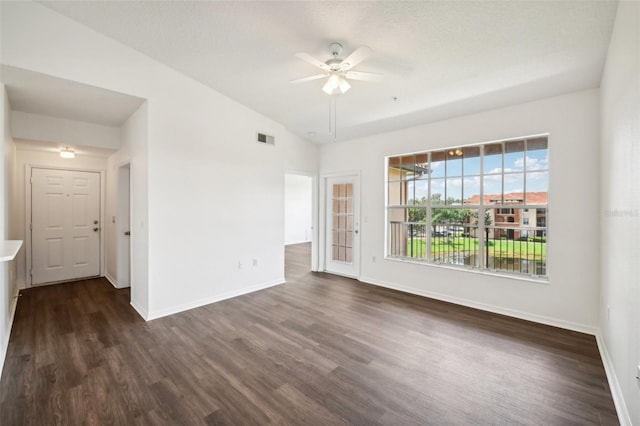 empty room featuring hardwood / wood-style flooring, vaulted ceiling, and ceiling fan