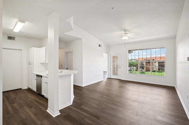 unfurnished living room featuring dark hardwood / wood-style flooring and ceiling fan