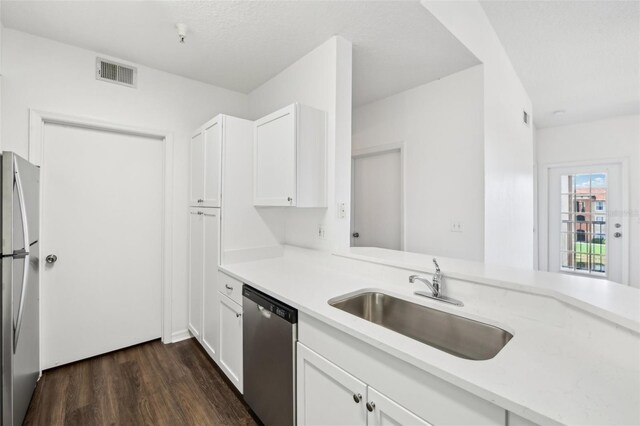 kitchen with sink, dark hardwood / wood-style flooring, white cabinetry, and stainless steel appliances