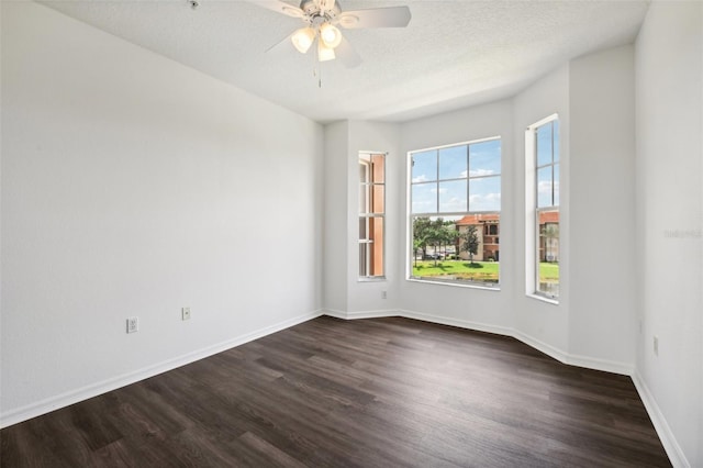 spare room featuring a textured ceiling, ceiling fan, and dark hardwood / wood-style floors