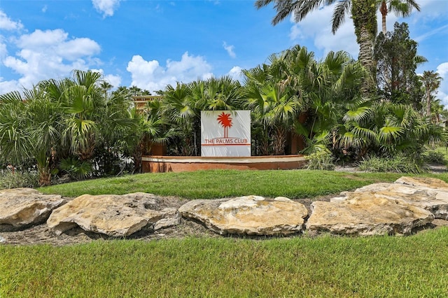 community / neighborhood sign with a lawn