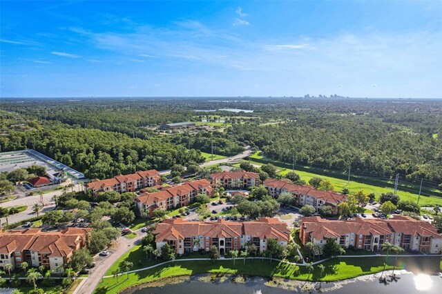 aerial view featuring a forest view and a residential view