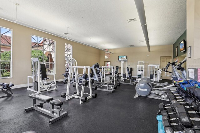 exercise room featuring a textured ceiling