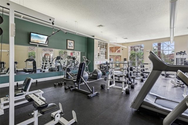 workout area featuring visible vents and a textured ceiling