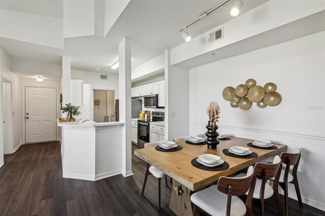 5536 Metrowest Blvd Unit 8-304, Orlando, FL 32811 - dining room with dark wood-style floors