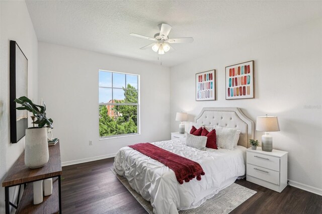 5536 Metrowest Blvd Unit 8-304, Orlando, FL 32811 - bedroom featuring baseboards, dark wood finished floors, a textured ceiling, and ceiling fan