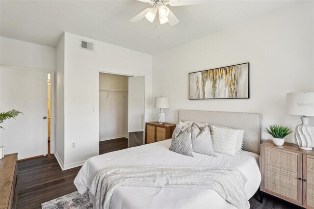 5536 Metrowest Blvd Unit 8-304, Orlando, FL 32811 - bedroom featuring wood finished floors, a closet, baseboards, ceiling fan, and a walk in closet
