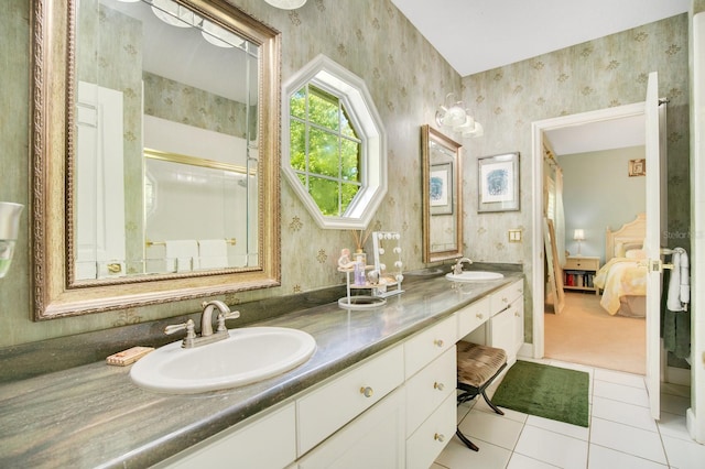 bathroom featuring tile patterned floors, vanity, and a shower with shower door