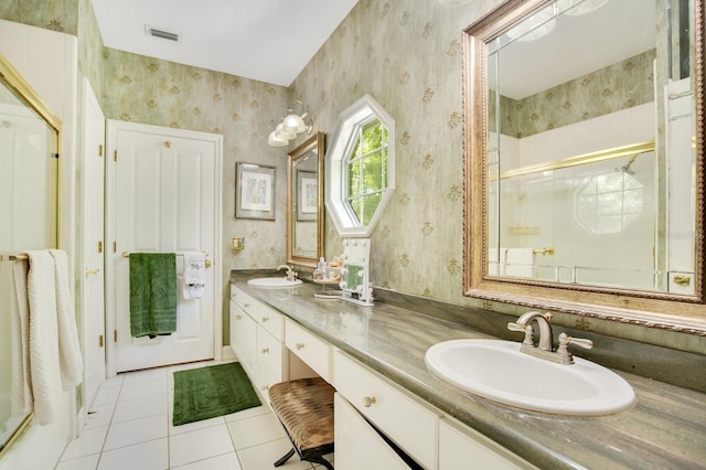 bathroom featuring vanity, a shower with shower door, and tile patterned flooring