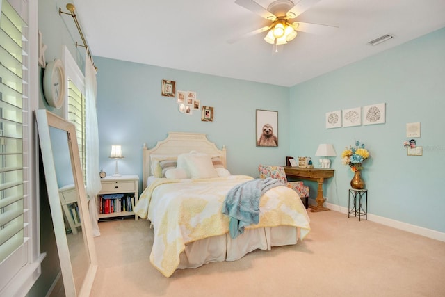 bedroom with light colored carpet and ceiling fan