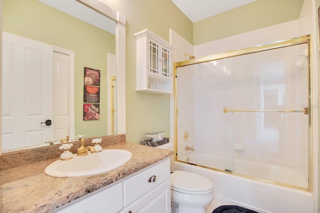 full bathroom featuring vanity, bath / shower combo with glass door, and toilet