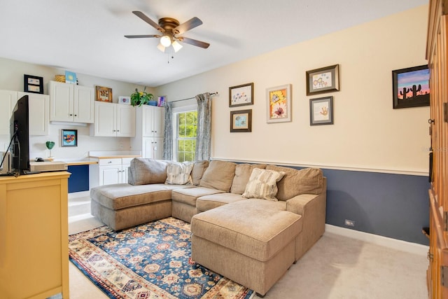 carpeted living room with ceiling fan