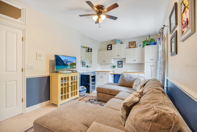 carpeted living room featuring ceiling fan and beverage cooler