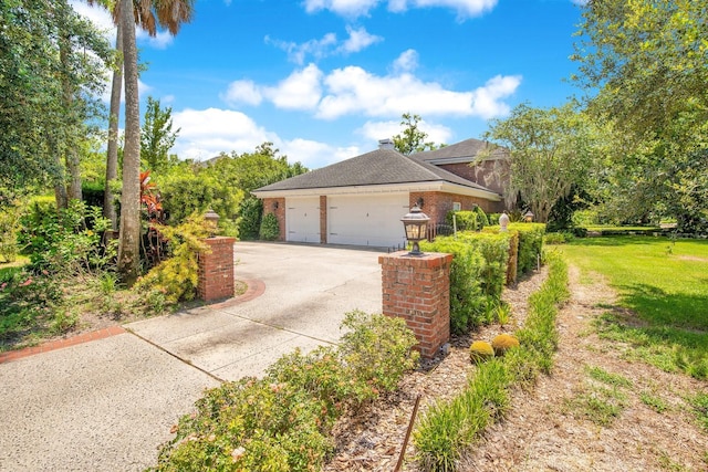 view of side of home featuring a garage and a yard