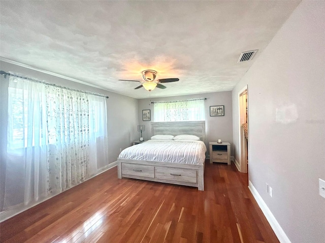 bedroom featuring ceiling fan and dark hardwood / wood-style flooring