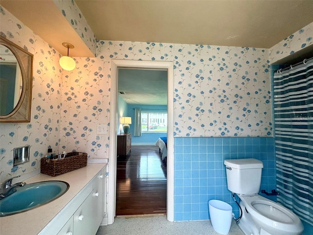 bathroom featuring vanity, toilet, and curtained shower