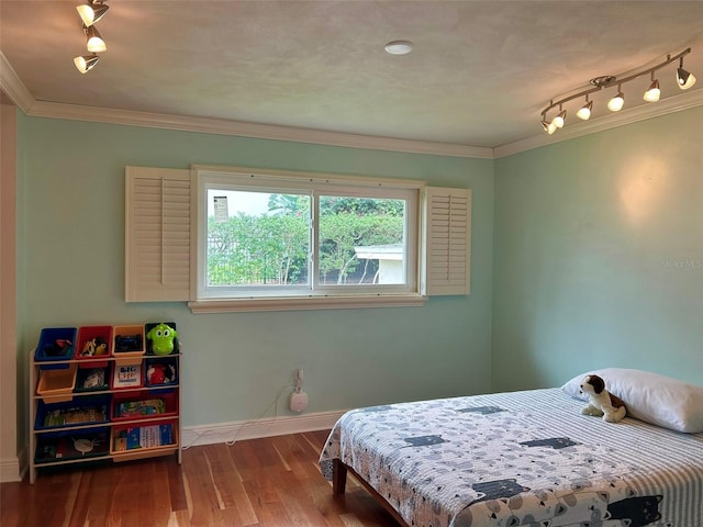 bedroom featuring ornamental molding and hardwood / wood-style flooring