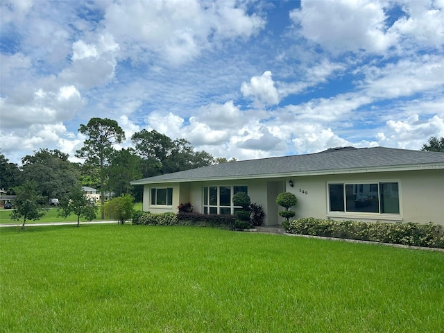 single story home featuring a front lawn