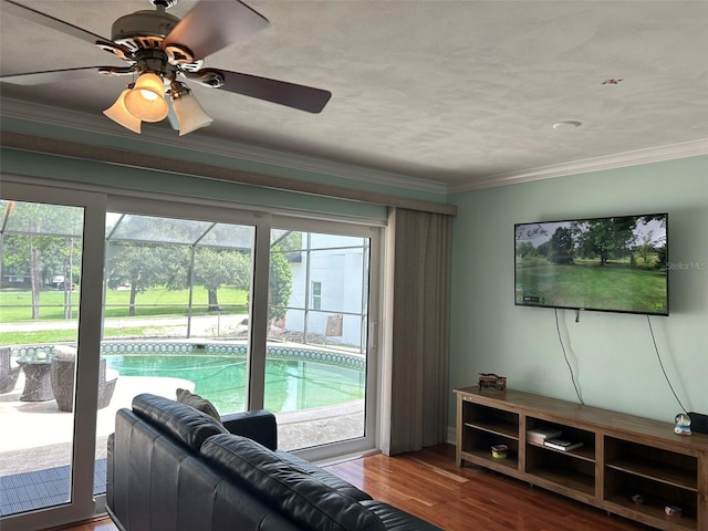 living room featuring a wealth of natural light, ceiling fan, ornamental molding, and hardwood / wood-style floors