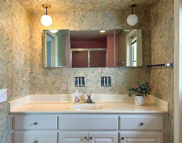 bathroom with vanity and a shower with shower door