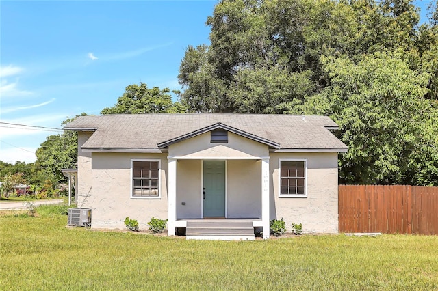 view of front of house featuring central AC and a front lawn