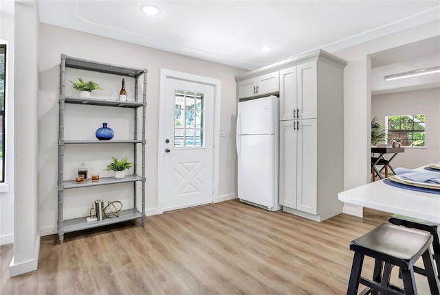 kitchen featuring light wood-type flooring and white fridge