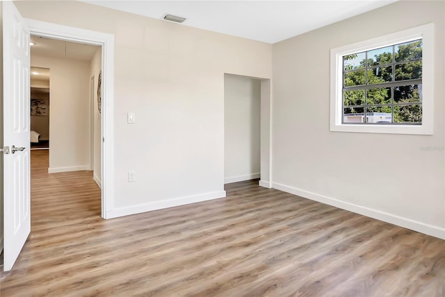 unfurnished bedroom with wood-type flooring and a closet