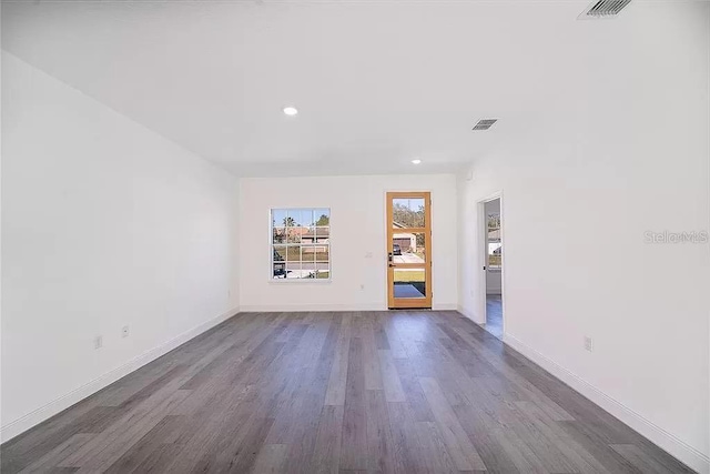 unfurnished living room featuring dark hardwood / wood-style floors