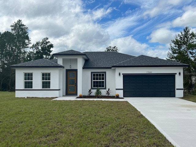 view of front of home with a front yard and a garage