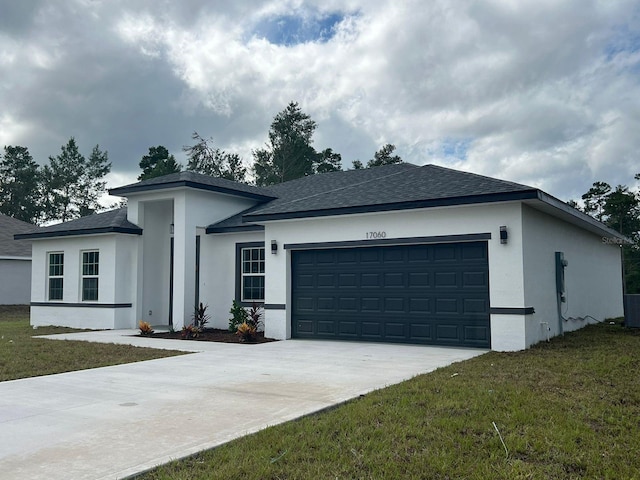 view of front of property with a garage and a front yard