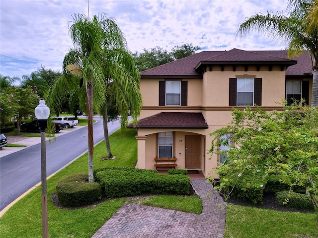 mediterranean / spanish-style house featuring a front lawn