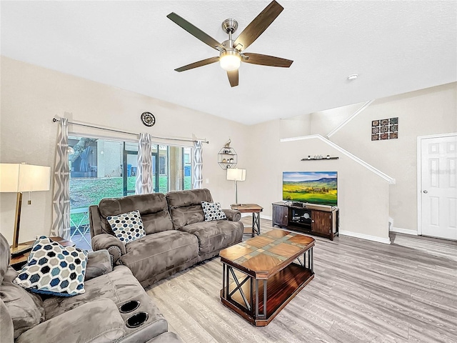 living room featuring ceiling fan and hardwood / wood-style flooring