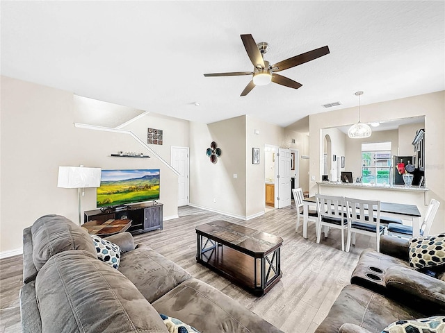 living room with hardwood / wood-style floors and ceiling fan