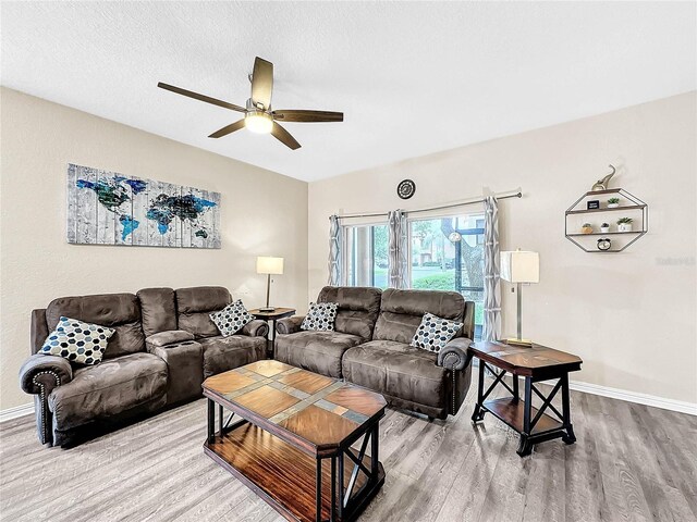 living room featuring a textured ceiling, ceiling fan, and hardwood / wood-style floors