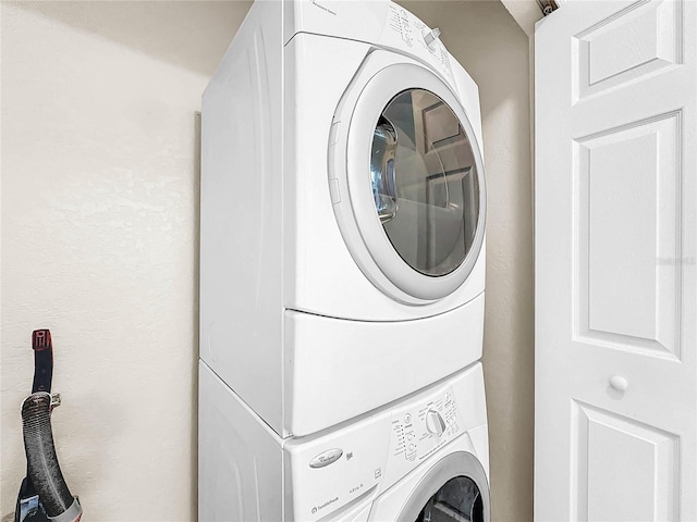 clothes washing area featuring stacked washer / dryer