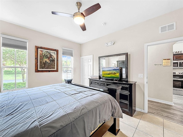 bedroom with ceiling fan and light tile patterned floors