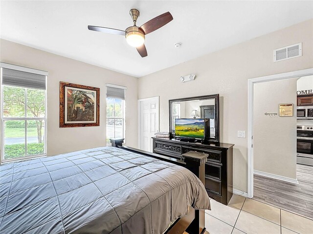 bedroom with light tile patterned flooring and ceiling fan